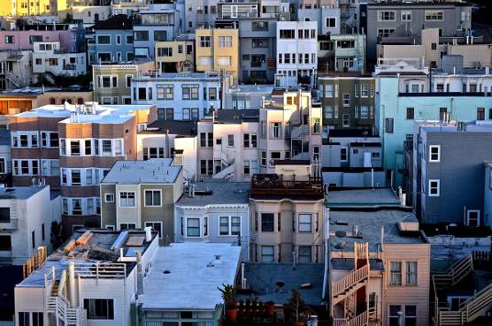 Victorian rooftops stacked above a San Francisco street